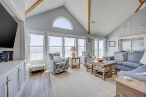 a living room with a couch and a table at 7048 - Tide Song in Rodanthe