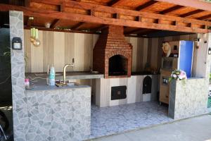 a kitchen with a pizza oven in a house at Pensiunea Melissa in Măceşu de Jos