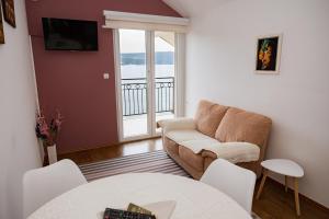 a living room with a couch and a table at Apartments LungoMare in Tivat