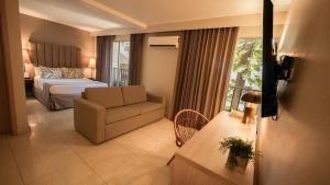 a hotel room with a bed and a couch and a chair at Madisson Boutique Hotel Cartagena in Cartagena de Indias