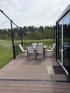 a wooden deck with a table and chairs on it at Peppa Puhkemaja in Vahtrepa