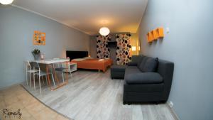 a living room with a couch and a table at Apartamenty Sedinum - Brama Portowa in Szczecin
