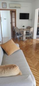 a living room with a couch and a table with chairs at Apartman Car in Vir