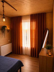 a bedroom with a bed and a window at Nia&Mari in Telavi
