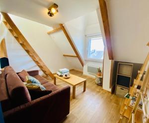 a living room with a couch and a table at Surf Hostel Quiberon in Saint-Pierre-Quiberon