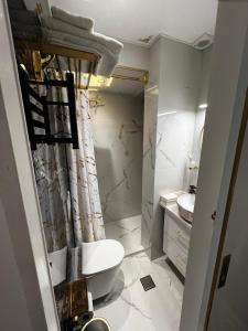 a white bathroom with a toilet and a sink at Boutique Sea & Garden in Vari +21 photos