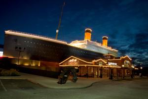 a large cruise ship sitting next to a building at By The Night in Pigeon Forge
