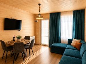 a living room with a blue couch and a table at Nia&Mari in Telavi