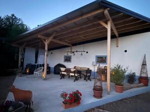 a patio with awning and a table and chairs at Lauenhainer Alm in Mittweida