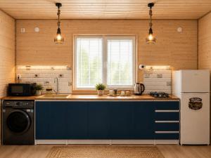 a kitchen with a blue counter and a refrigerator at Nia&Mari in Telavi