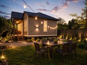 a tiny house with a table and chairs in the yard at Nia&Mari in Telavi