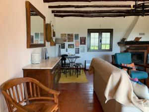 a living room with a couch and a table at Rustic Villa with Private Pool near Ericeira in Mafra