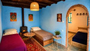 a bedroom with two beds and an arched doorway at Caiat Lounge Refuge , Mountain Lodge near Akchour Waterfalls in Taghzoute +59 photos