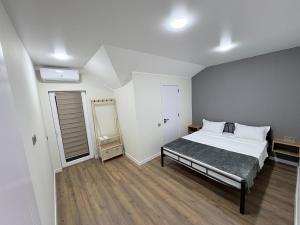 a bedroom with a bed and a mirror in it at EmiLiza in Kobuleti
