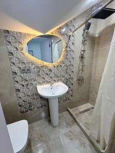 a bathroom with a sink and a mirror at EmiLiza in Kobuleti +33 photos