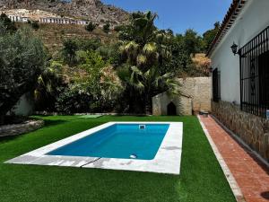 a swimming pool in the yard of a house at Cortijo Algüit in Vélez Blanco