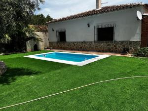 a swimming pool in a yard next to a house at Cortijo Algüit in Vélez Blanco +6 photos