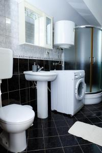 a bathroom with a toilet sink and a washing machine at Apartments LungoMare in Tivat +72 photos