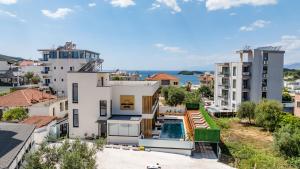 an aerial view of a building with a swimming pool at Aura Mare Hotel in Ksamil