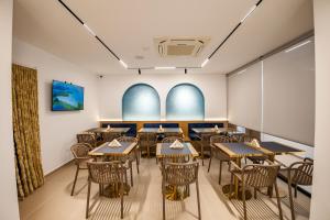 an empty dining room with tables and chairs at Aura Mare Hotel in Ksamil +198 photos