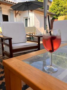 a glass of red wine sitting on a table at Amis Wine House - Maison d'hôtes à 5 min de Saint-Émilion in Pomerol