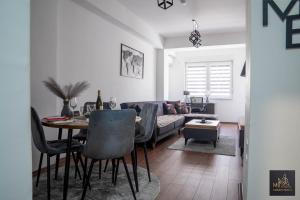 a living room with a table and a couch at M2 Apartments in Štip