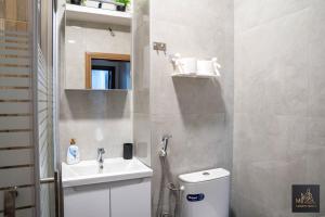 a bathroom with a toilet and a sink at M2 Apartments in Štip +18 photos