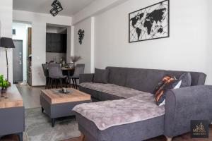 a living room with a couch and a table at M2 Apartments in Štip