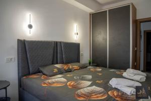a bedroom with a bed with towels on it at M2 Apartments in Štip
