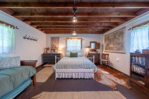 a bedroom with a bed and a couch at Cozy Cabin w Pavilion Deck Fireplace & FirePit in Terra Alta