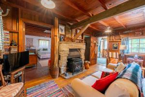a living room with a couch and a fireplace at Cozy Cabin w Pavilion Deck Fireplace & FirePit in Terra Alta +19 photos