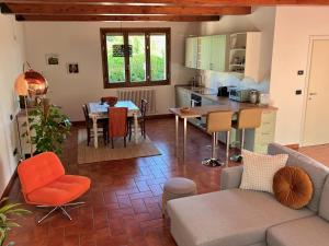 a kitchen and living room with a couch and a table at Dolce Collina, Sunset Terrace & Vineyard Views in Dozza +23 photos