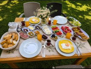 a picnic table with breakfast food on it at Çıralı Camping in Cıralı +8 photos