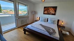 a bedroom with a bed with a picture of a cow on the wall at Feel Home Apartment in Dornbirn