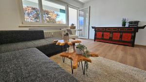 a living room with a couch and a table at Feel Home Apartment in Dornbirn