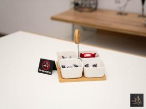 a serving tray with three bowls and a spoon at М Apartments Shtip in Štip +18 photos