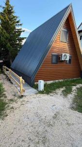 a house with a roof with a speaker on it at Vila Mia in Žabljak +4 photos
