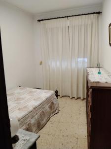 a bedroom with a bed and a large window at O Recuncho da Xunqueira in Viveiro