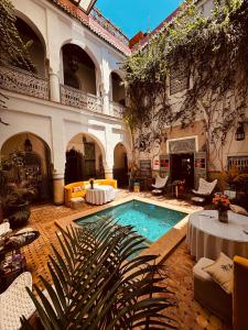 a courtyard with a swimming pool in front of a building at Riad Dar Al Assad in Marrakesh
