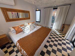a bedroom with a bed and a checkered floor at Stipa Boutique Hotel in Chacras de Coria