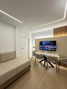 a living room with a couch and a tv on the wall at Villa Ani in Borsh