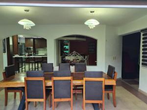 a dining room with a wooden table and chairs at Cocoyoc Residential Estate in Texcalpan