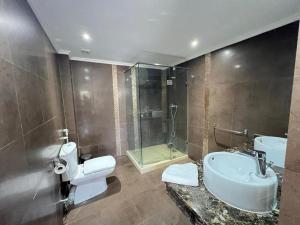 a bathroom with a toilet and a sink and a shower at Villa Marina à Savannah Beach sidi rahal in Sidi Rahal +18 photos
