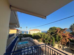 a balcony with a view of a swimming pool at Thalassa Home B in Chiliadou