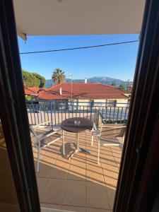 a view of a balcony with a table and chairs at Thalassa Home B in Chiliadou