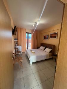 a hotel room with a bed and a balcony at Thalassa Home B in Chiliadou