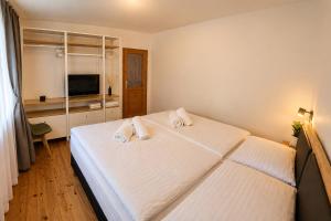 a bedroom with a bed with two towels on it at Apartmány Lipno 46 in Lipno nad Vltavou