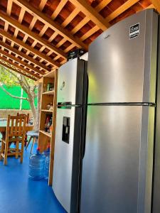 a stainless steel refrigerator sitting in a kitchen at Casa Mahue in Puerto Escondido