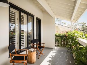 a porch with two chairs and a table on it at Hotel Carmel in Carmel