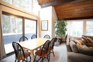 a dining room with a table and a couch at Sunnyside 6 in Condo Waterville Valley in Waterville Valley